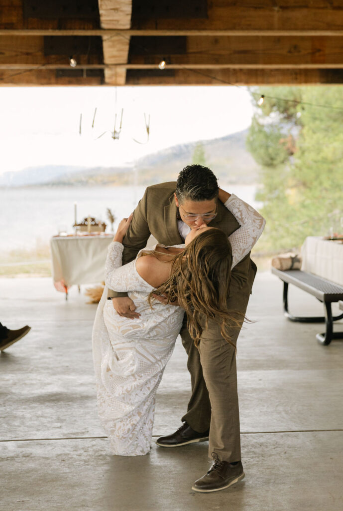 bride and groom dip kiss at the wedding reception space at windy point