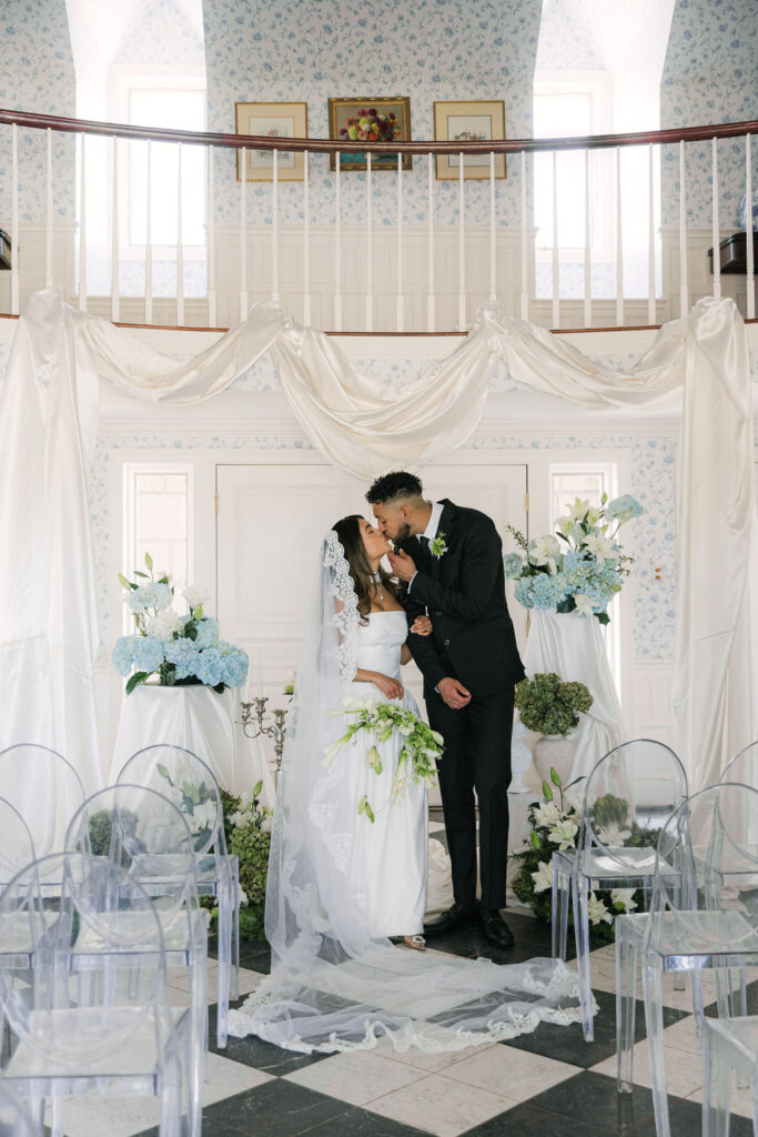 bride and groom kissing at the indoor ceremony space at greystone castle boulder
