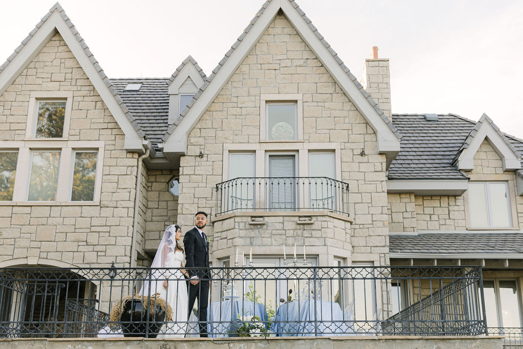 bride and groom at the balcony of greystone castle wedding venue