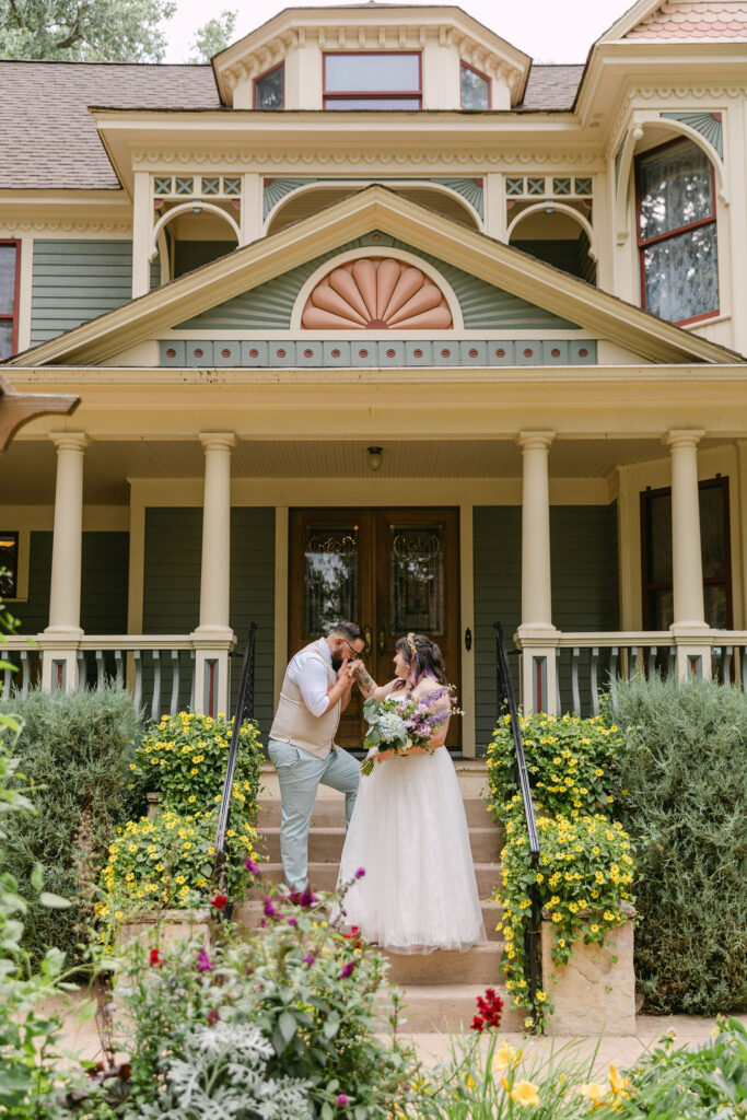 bride and groom in front of the tapestry house