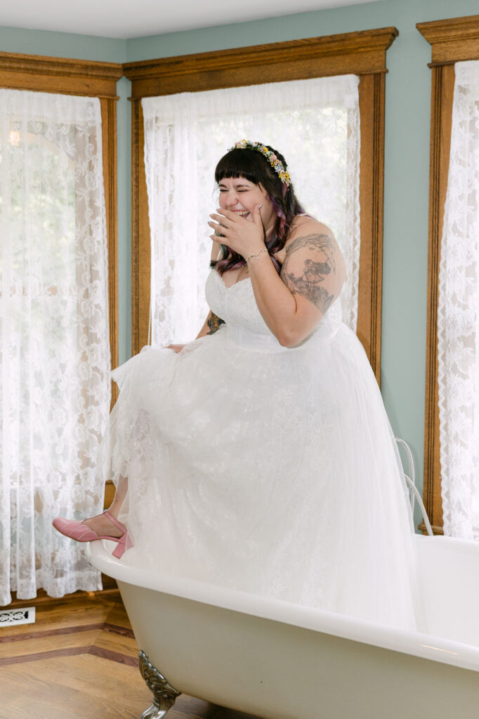 joyful bride inside a claw foot bathtub at the tapestry house