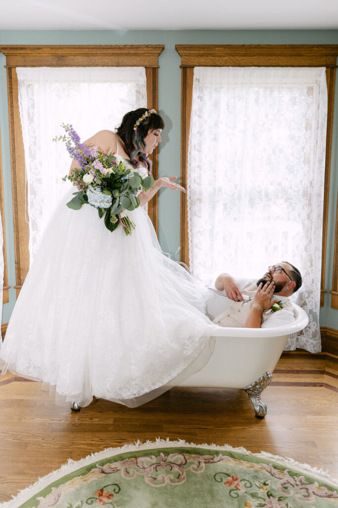 fun bride and groom inside a claw foot bathtub at the tapestry house