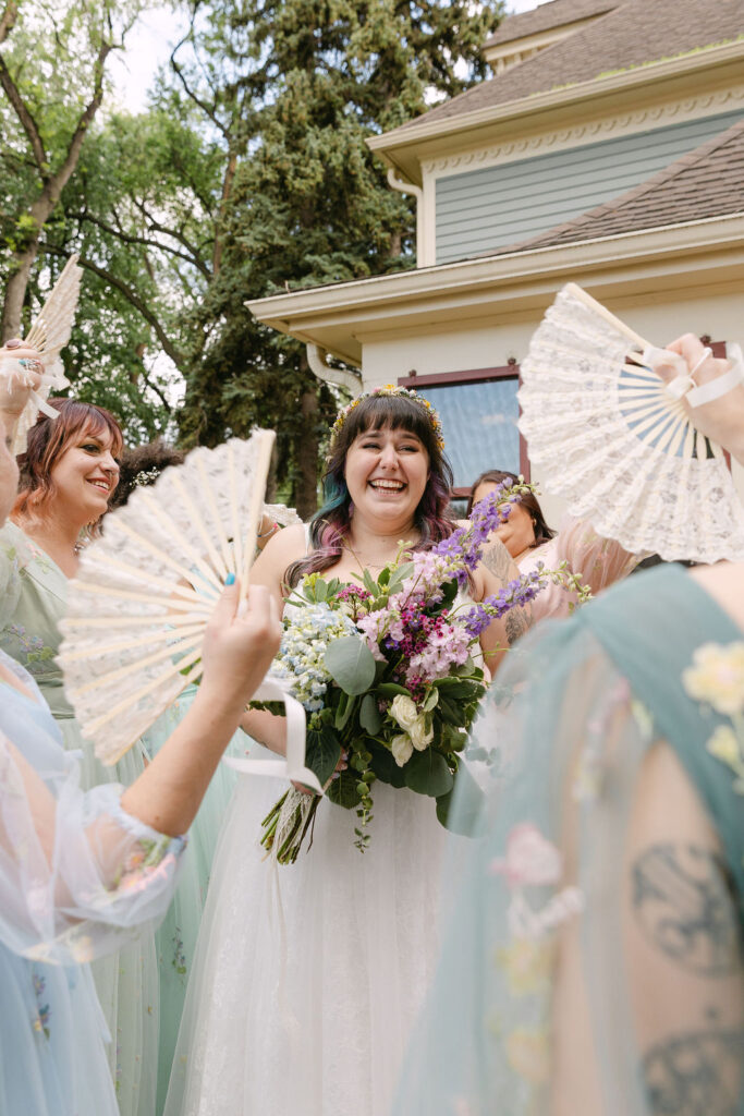 candid bride and bridesmaids, bridesmaids wearing pastel mismatched dresses