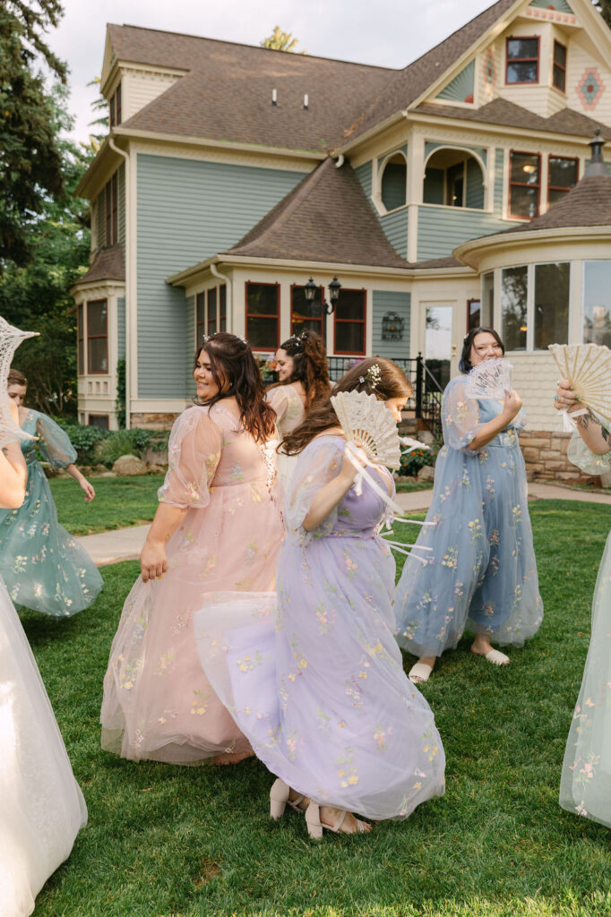 candid bride and bridesmaids, bridesmaids wearing pastel mismatched dresses