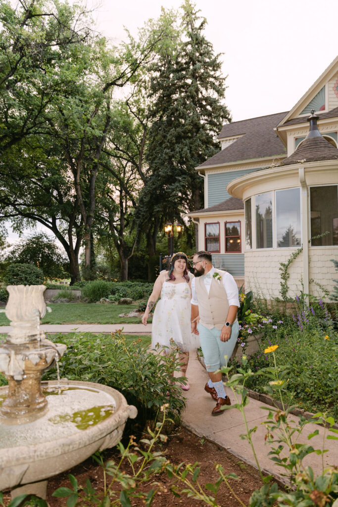 joyful bride and groom roaming around the grounds of the tapestry house by wedgewood weddings