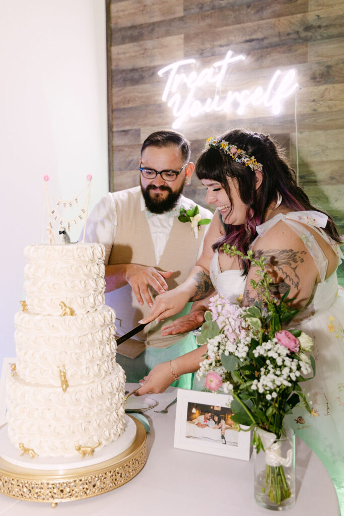 bride and groom cutting cake
