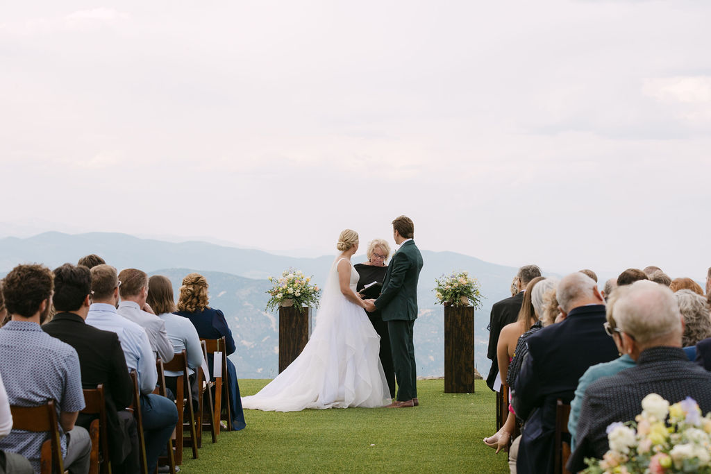 Bride and groom hold hands during their Echo Mountain wedding ceremony 