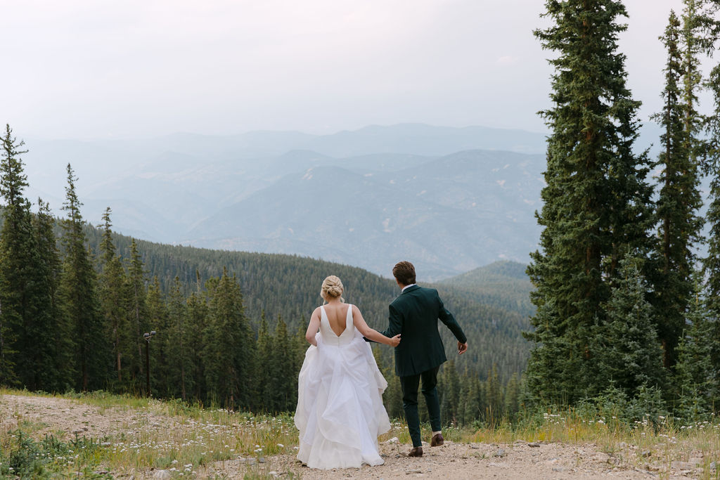 Bride and groom frolicking in the mountains at blue hour at the Echo Mountain ski resort 
