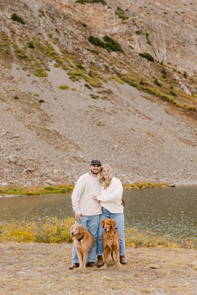 Gorgeous fall photo session of a couple with their 2 dogs by a lake on Loveland Pass