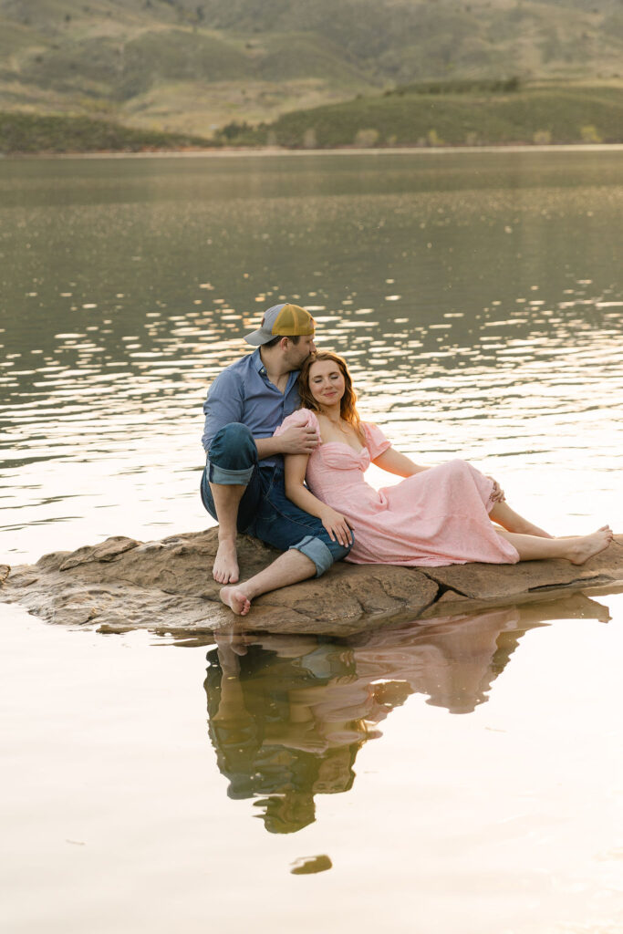 Annelise leaning her head on Ross’s shoulder while sitting by the water.
