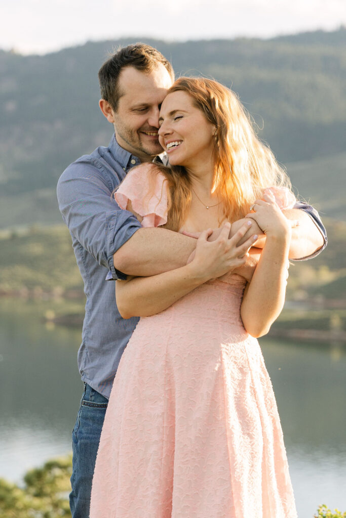Close-up portrait of the couple smiling at each other in the golden light during their fort collins engagement photos.