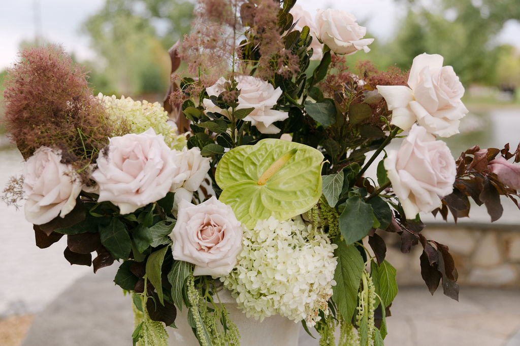 Fine-art floral arrangement with blush roses and greenery for an elegant garden wedding in Colorado.