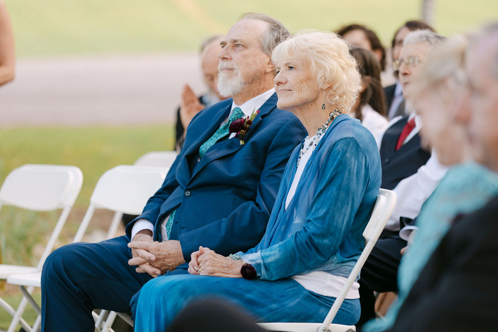 Wedding guests watching the ceremony at Hudson Gardens, a Colorado outdoor wedding venue.