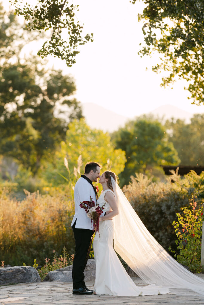Golden-hour bride and groom portrait at Hudson Gardens, showcasing a luxury Colorado wedding with natural light photography.