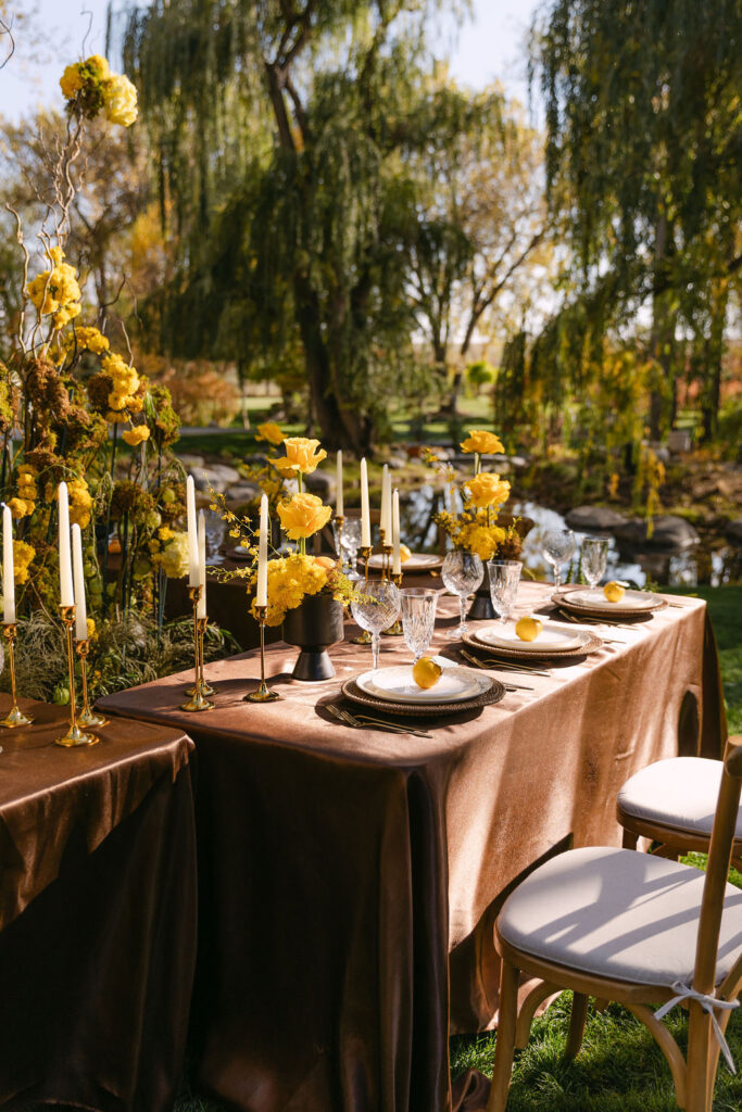 Chocolate brown reception linens with the sunlight gleaming off of them at an outdoor Colorado wedding venue 