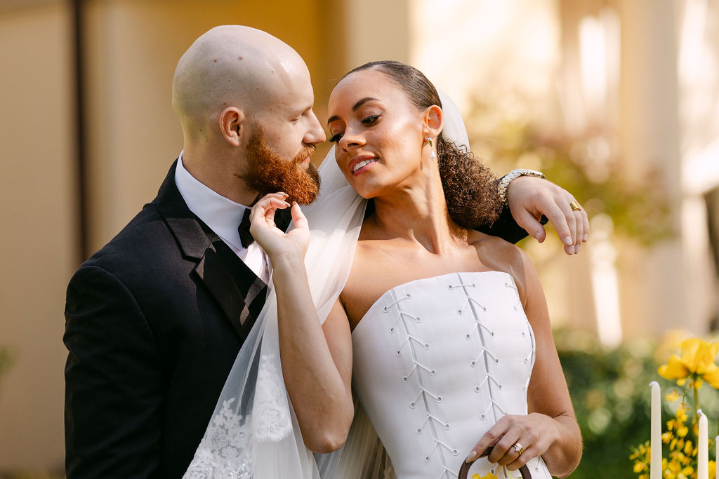 Bride and groom lovingly staring into each other's eyes during their wedding portraits at Oceana's Gardens 
