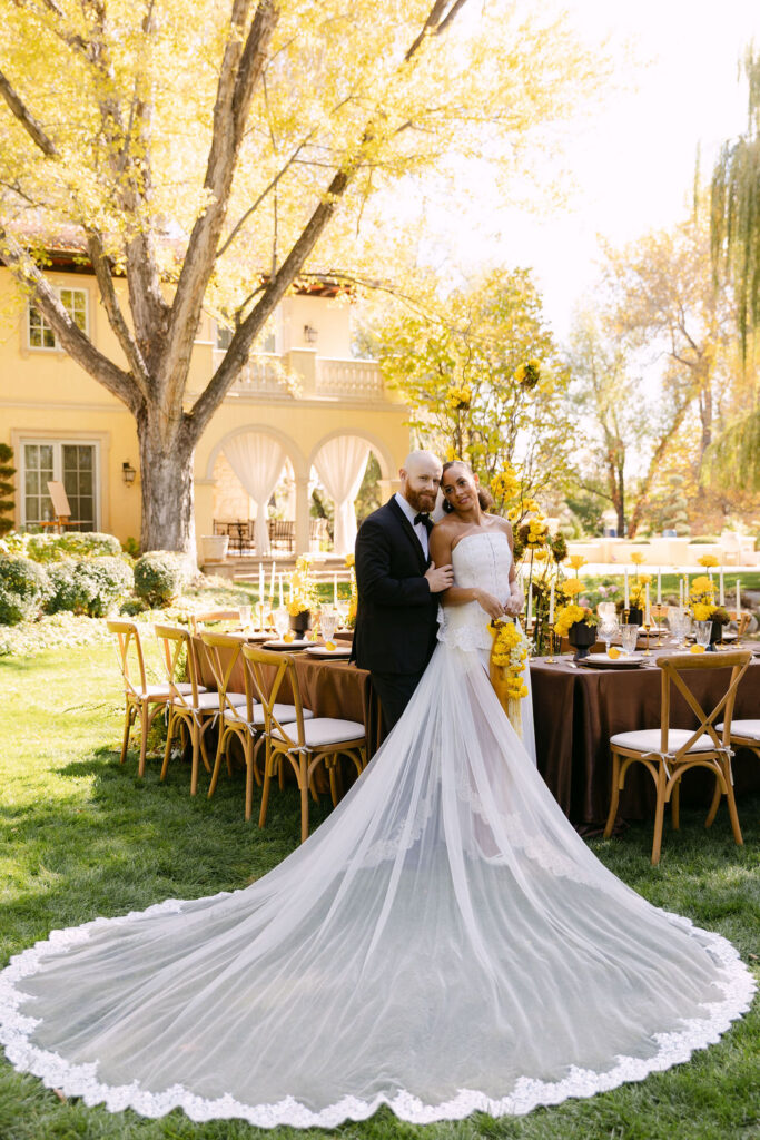 Timeless wedding portrait of bride and groom hugging with her cathedral length veil fully displayed at Oceana's Gardens captured by Colorado wedding photographer Mrs. Ferree Photography 
