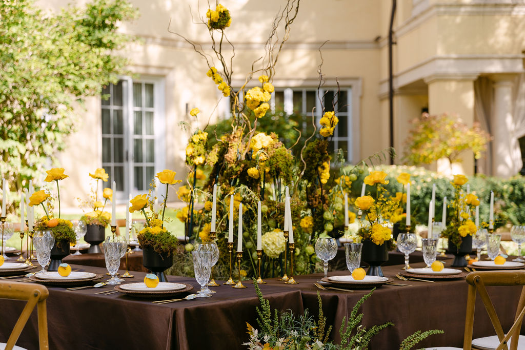Luxury, colorful wedding florals displayed in between the reception tables as a statement piece at Oceana's Gardens 