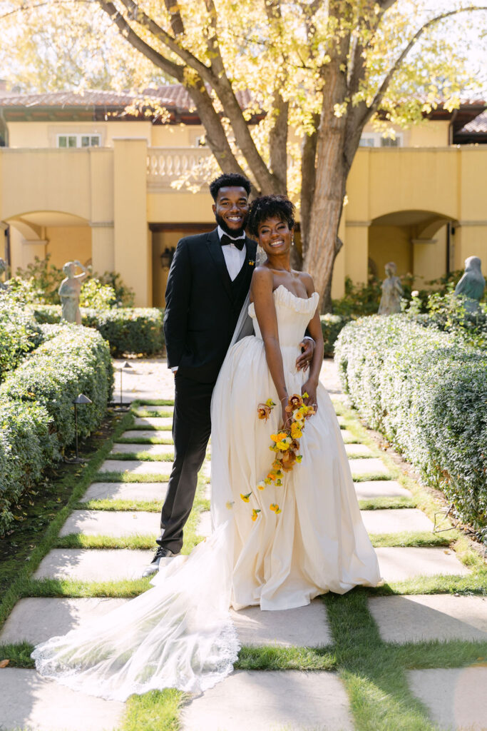 Bride and groom smiling for a timeless fine art wedding portrait at a luxury wedding venue in Colorado 