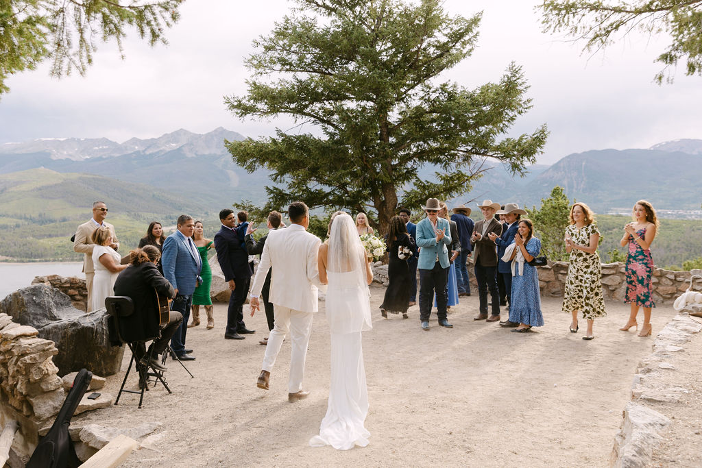 Friends and family cheering for the couple at their Sapphire Point Overlook wedding ceremony