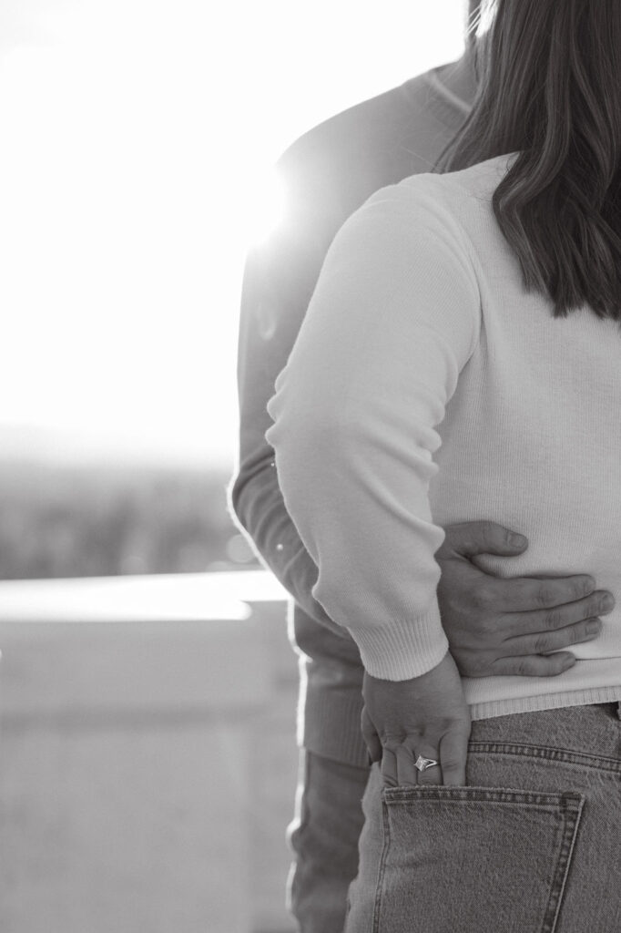 Close-up detail shot of couple holding each other during their Inspiration Point Park engagement session.