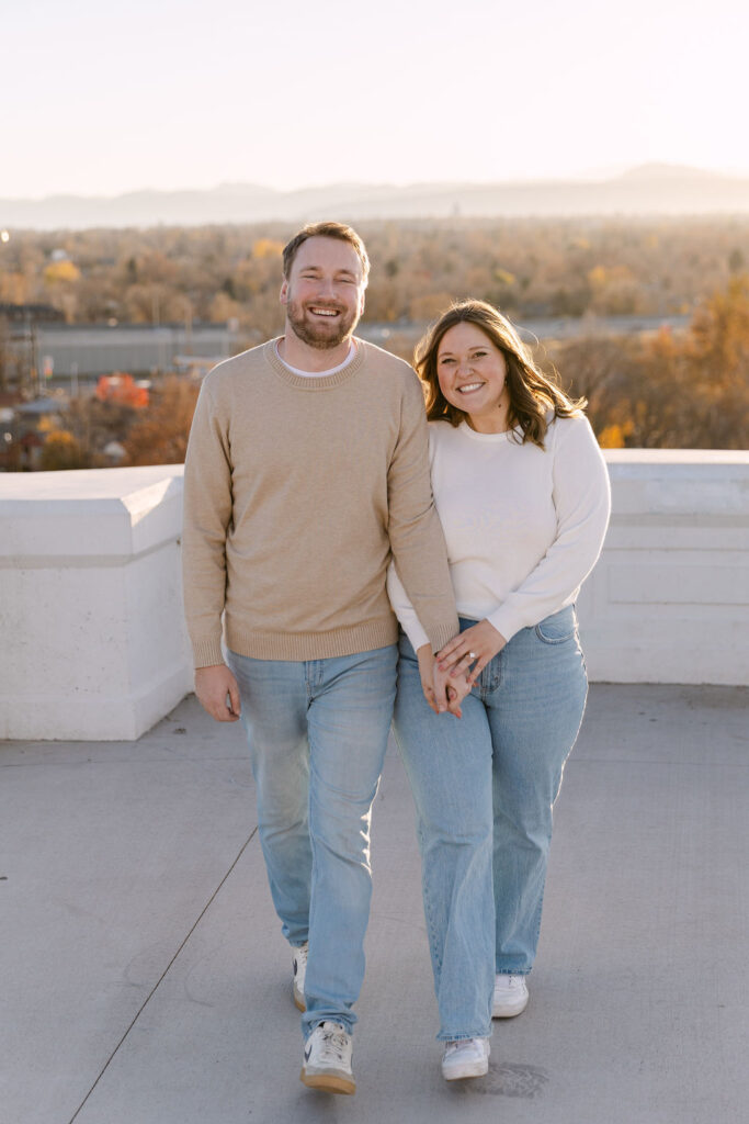 Couple walking together on the overlook path during their Denver engagement photos