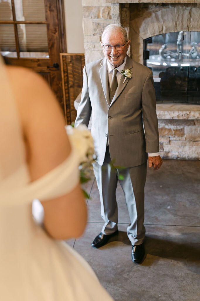 Bride doing a first look with her grandfather in the lodge at Spruce Mountain Ranch 