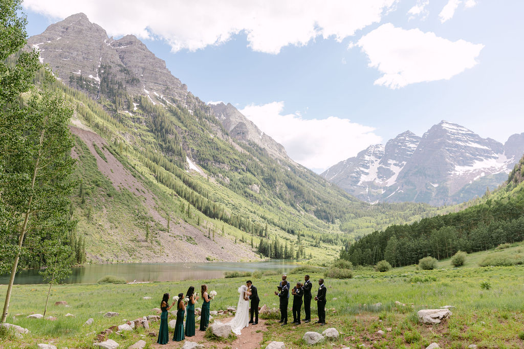 First kiss at a micro wedding ceremony in Aspen, Colorado at the Maroon Bells Amphitheater