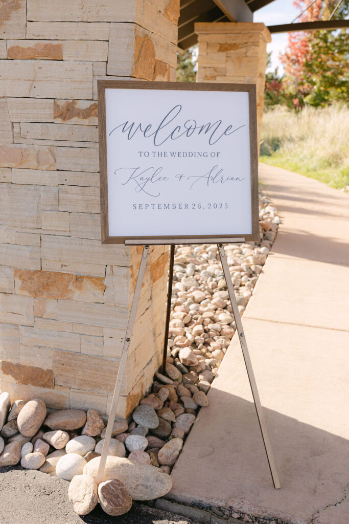 Elegant welcome sign displayed outside the ceremony pavilion at Spruce Mountain Ranch.