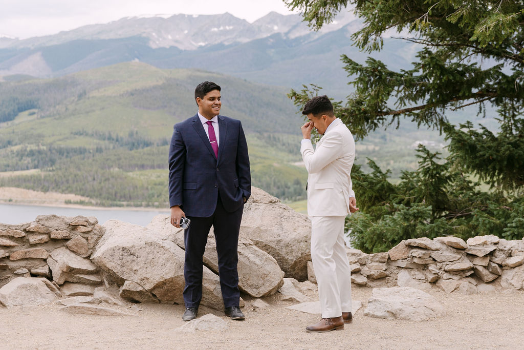 Emotional groom reacting to his bride during their mountain wedding ceremony in Colorado