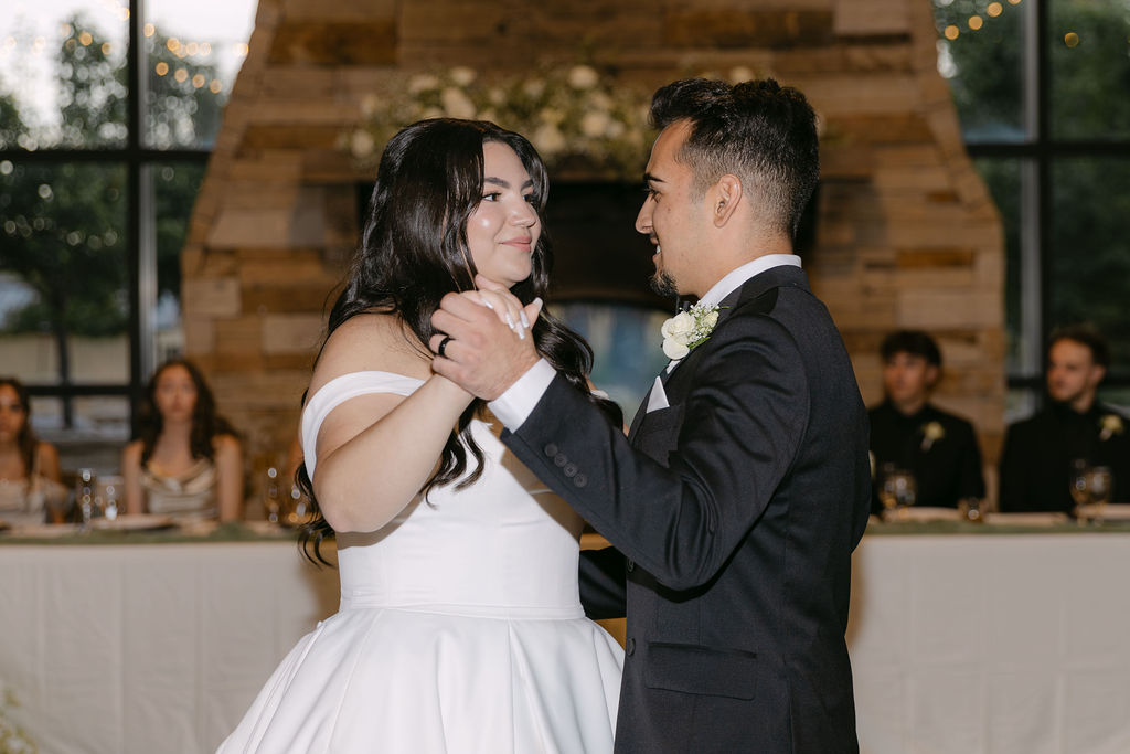 Bride and groom sharing their first dance inside Spruce Mountain Ranch’s reception barn.