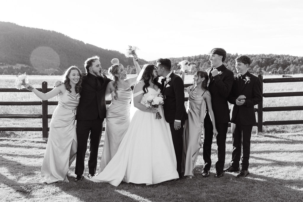 Black and white wedding party portrait celebrating at Spruce Mountain Ranch.