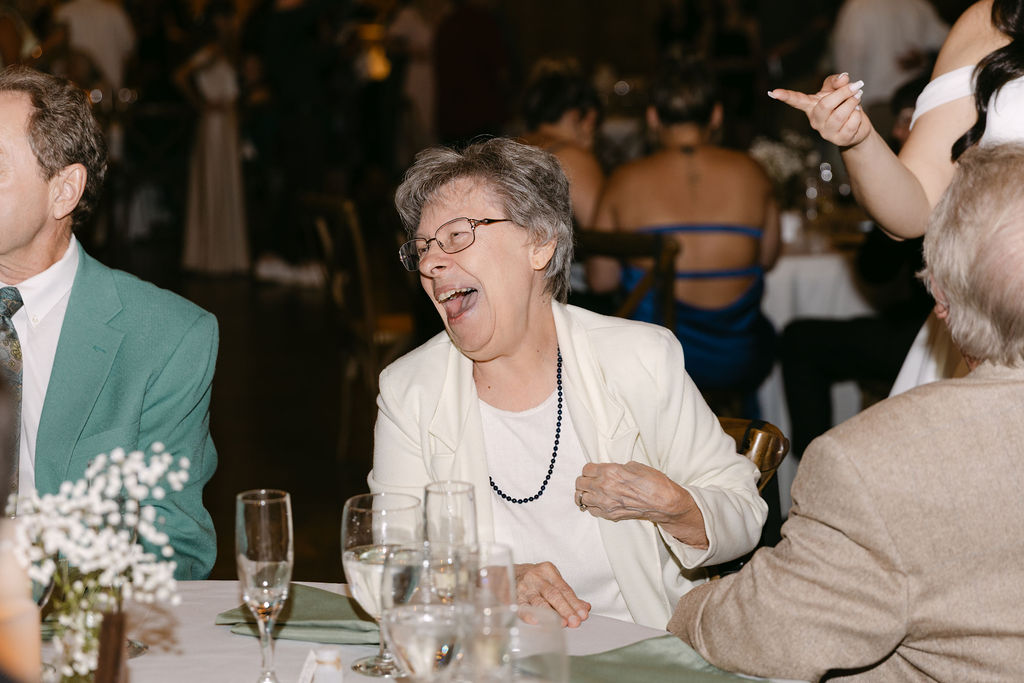 Guests reacting during reception speeches at the luxury Colorado wedding.