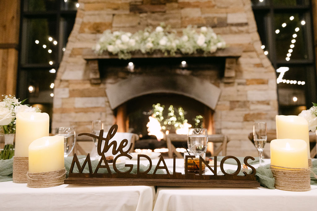 Close-up of stone fireplace decorated with florals and candlelight at Spruce Mountain Ranch reception.