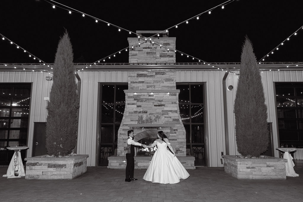 Nighttime portrait of bride and groom outside under string lights at Spruce Mountain Ranch.
