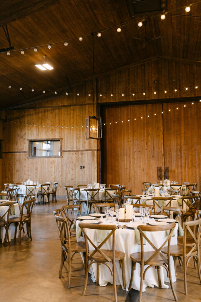 Elegant reception tables inside the lodge at Spruce Mountain Ranch with luxury rustic décor.