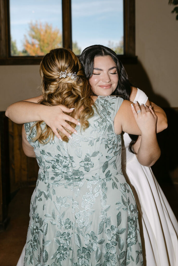 Bride hugging her mother during getting-ready moments at Spruce Mountain Ranch.