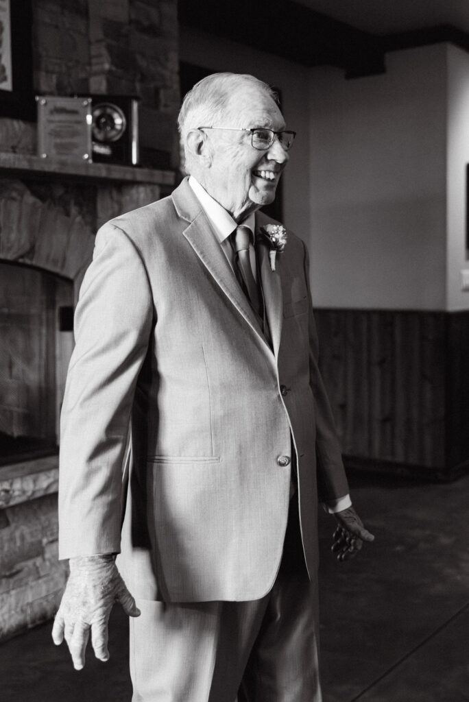 Candid, joyful reaction by the bride's grandfather during their first look before he walks her down the aisle 