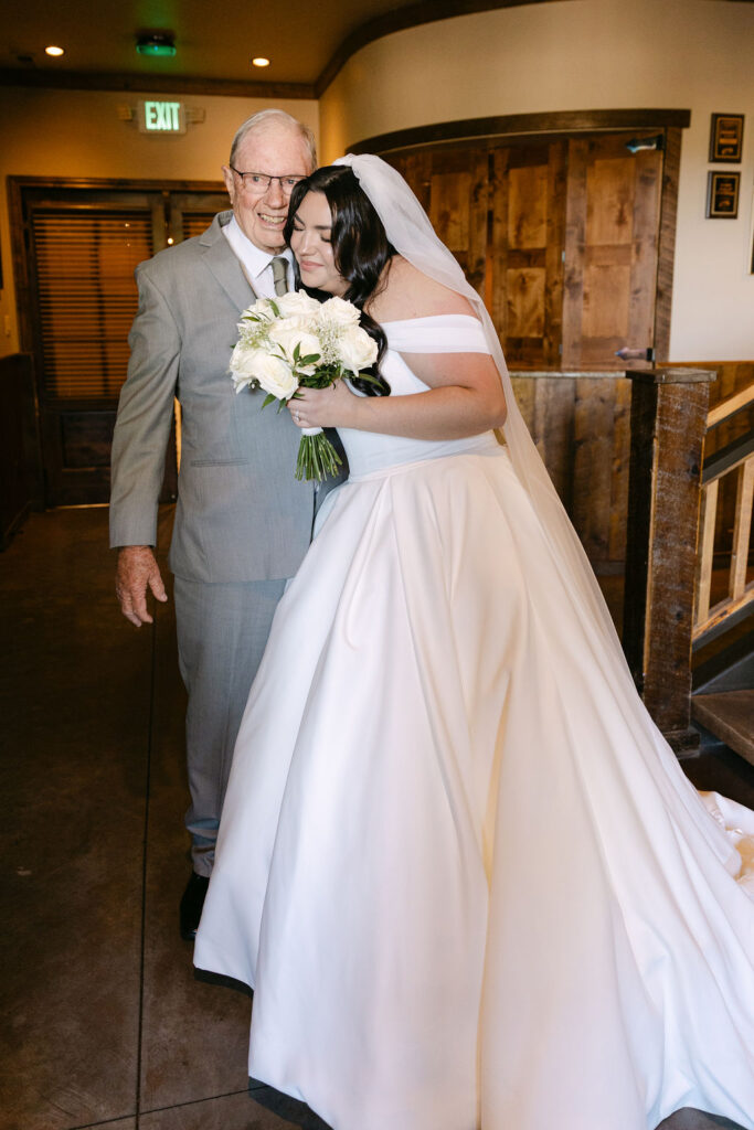 Bride hugging her grandfather before her wedding ceremony at Spruce Mountain Ranch