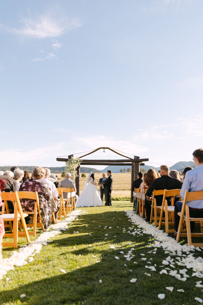 Ceremony aisle lined with white petals at Spruce Mountain Ranch.