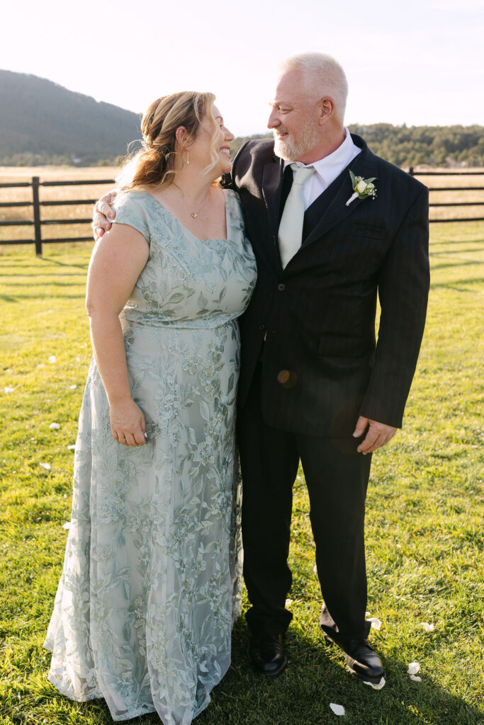 Parents sitting together outside the lodge at Spruce Mountain Ranch.
