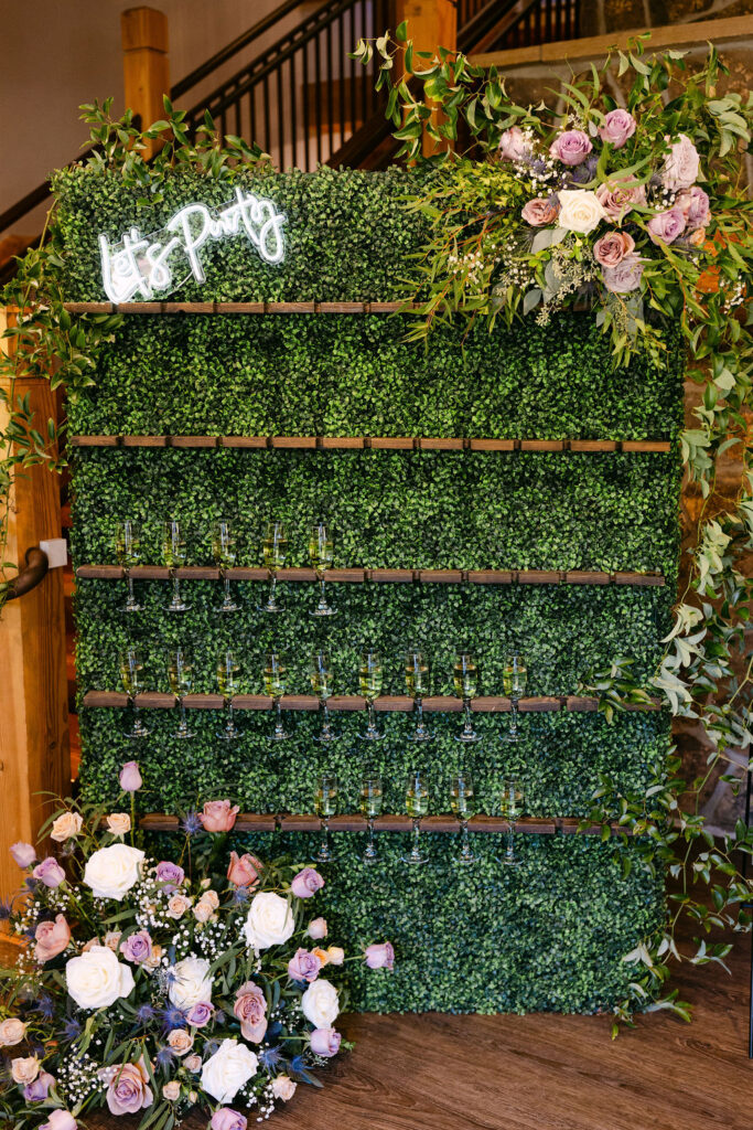 A champagne wall with florals stands inside Wild Basin Lodge in Allenspark, Colorado, in Rocky Mountain National Park.
